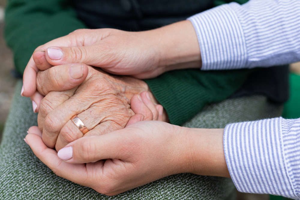 Holding hands and providing dementia care and support